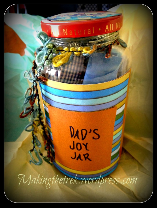 Pasta jar.  Cleaned.  Scrapbook paper cut and glued with fancy ribbon to tie around top